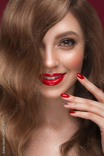 Beautiful girl with a classic makeup, curls hair and red nails. Manicure design. Beauty face.