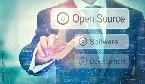 Fotografie A business man selection a Open Source button on a futuristic display with a concept written on it