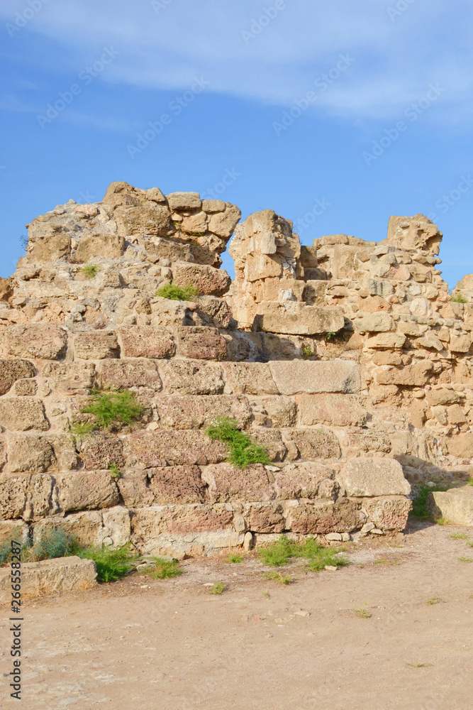 Ruins of the walls belonging to famous Salamis complex in Turkish Northern Cyprus. Salamis was a famous ancient Greek city-state. Taken on a sunny day with blue sky above