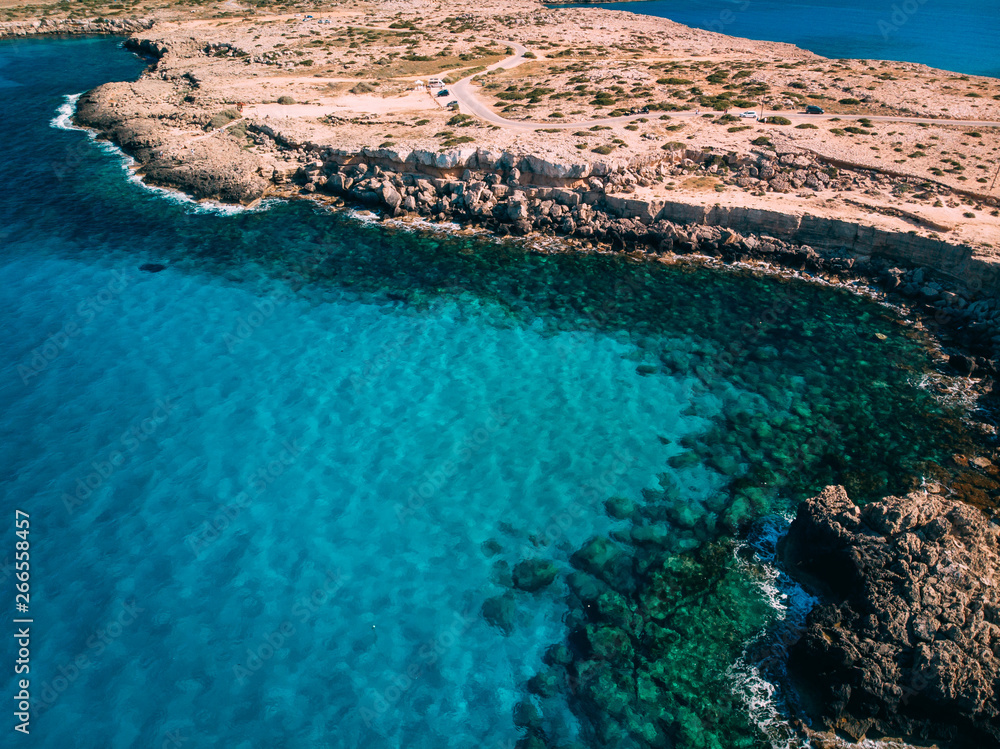Aerial Rocky sea shore with crystal clear blue water, Cyprus, Blue Lagoon