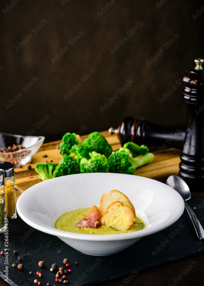 Broccoli cream soup with bread on a table. Classic European food