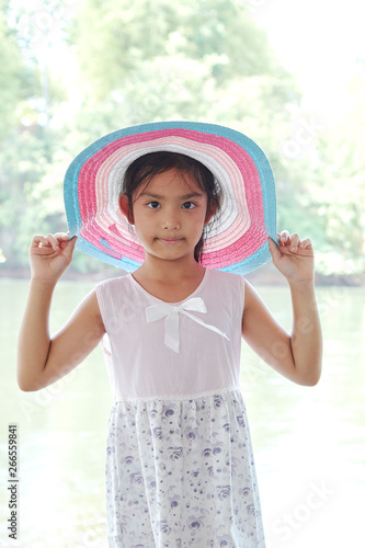 Little Asian Girl outdoors in summer hat