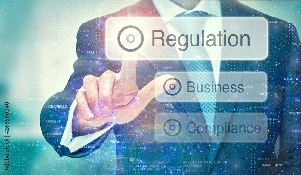 A business man selection a Regulation button on a futuristic display with a concept written on it. A business man selection a Regulation button on a futuristic display with a concept written on it.