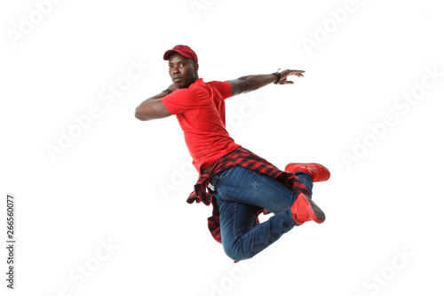 Young black stylish guy in red in a jump isolated on white background.
