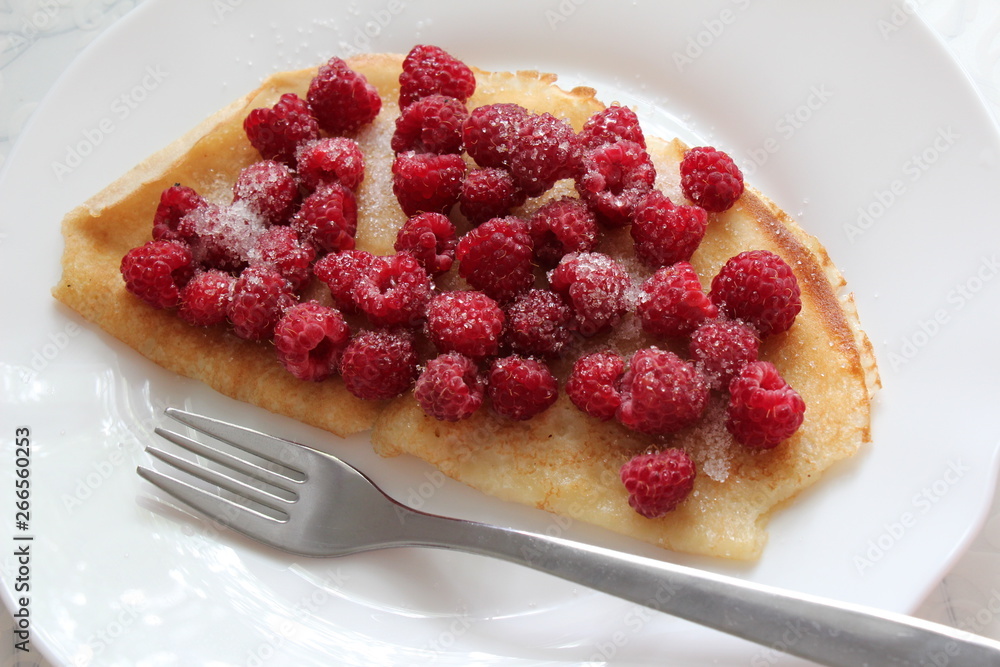 Delicious pancake with fresh raspberries on plate Delicious pancake with fresh raspberries on plate