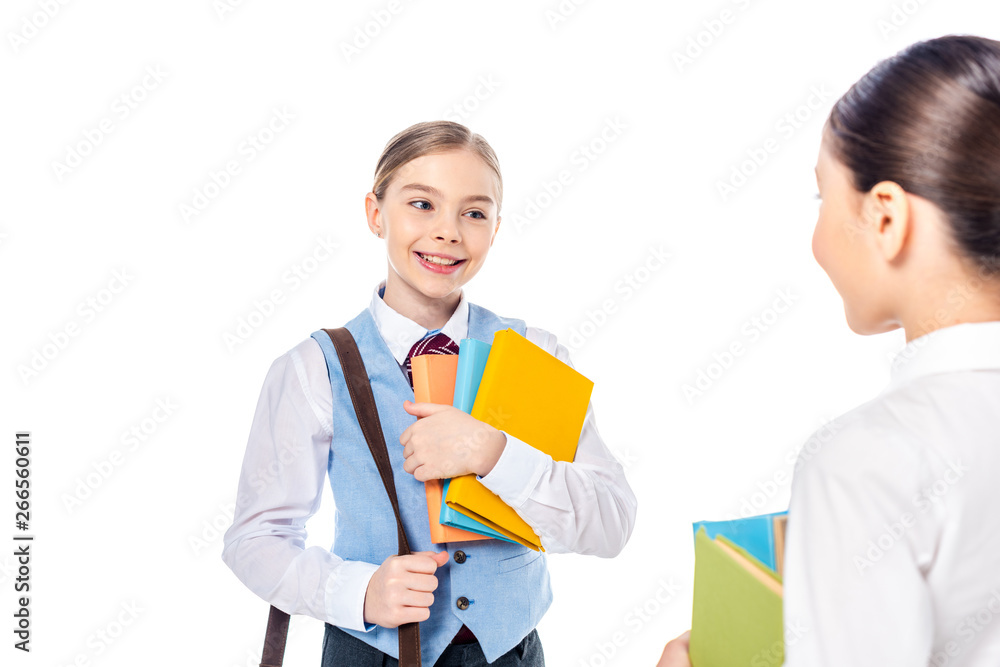 schoolgirls in formal wear with books looking at each other Isolated On White schoolgirls in formal wear with books looking at each other Isolated On White