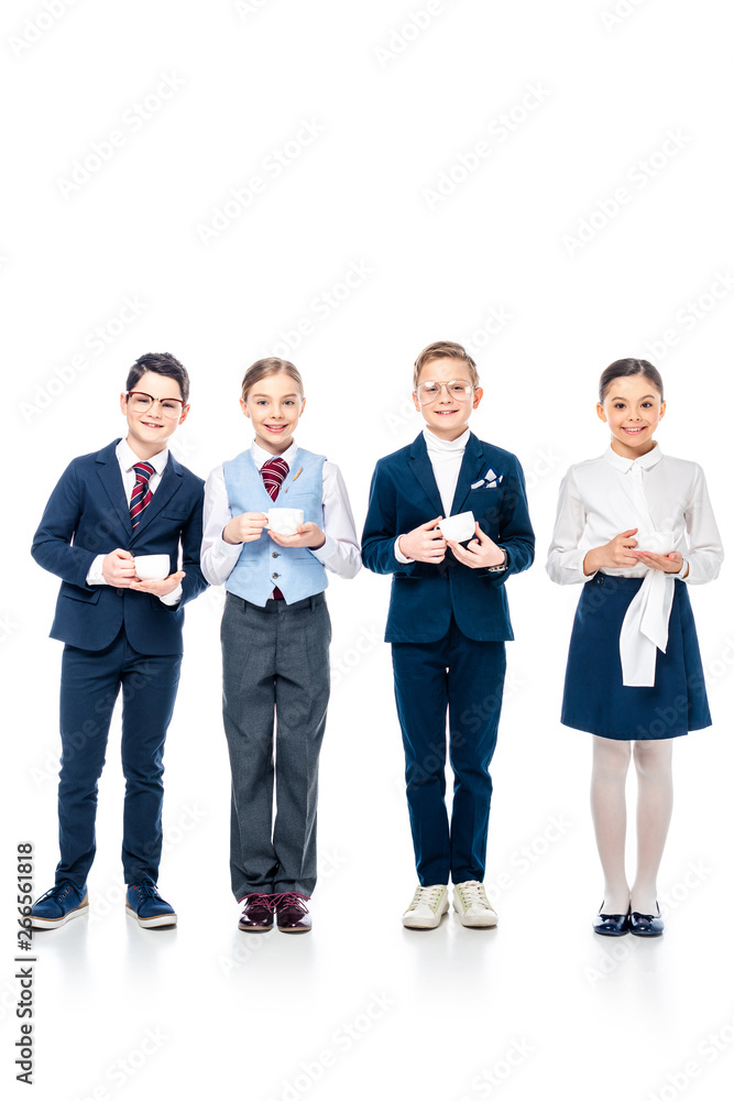 smiling schoolchildren pretending to be businesspeople holding coffee cups and looking at camera On White smiling schoolchildren pretending to be businesspeople holding coffee cups and looking at camera On White
