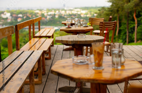 Tables in an empty cafe with a beautiful view of the city © Daria Mladenovic
