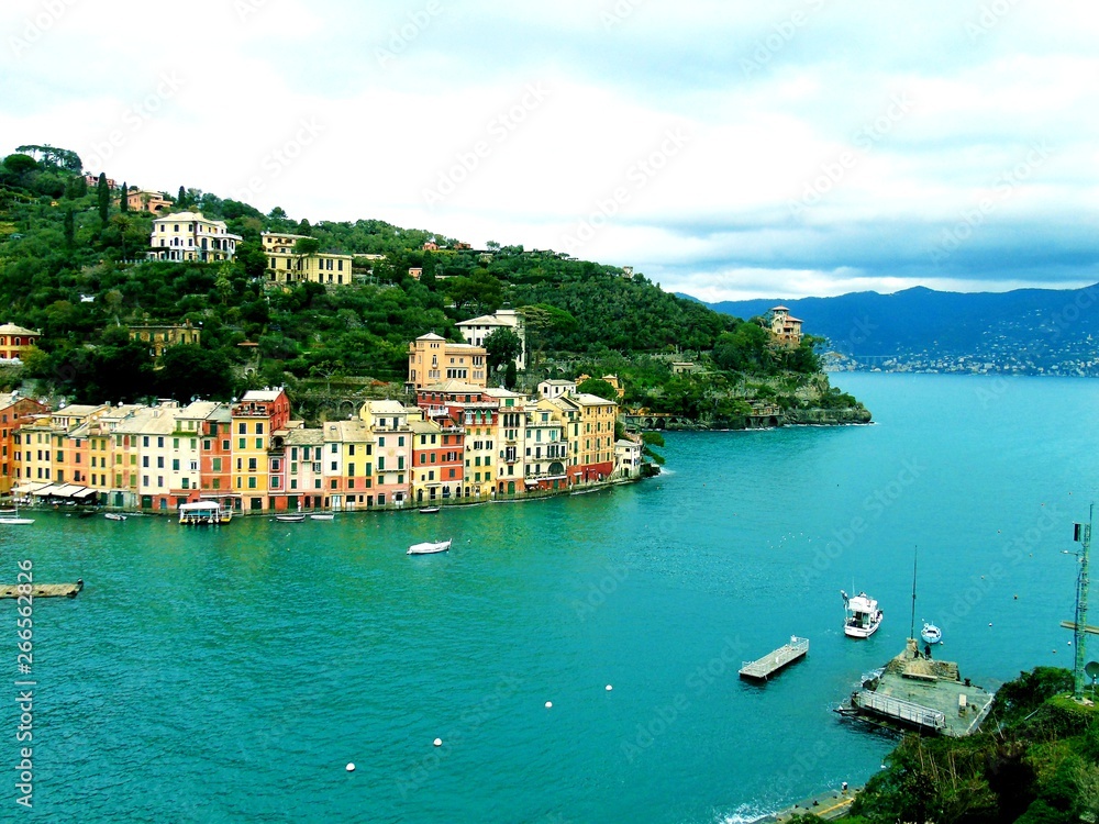 PORTOFINO , ITALY - MAY 02, 2019: The beautiful Portofino with colorful houses and villas, luxury yachts and boats in little bay harbor. Liguria, Italy, Europe