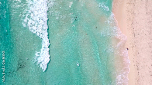 Unique straight down aerial view of people swimming at a tropical beach in Cozumel, Mexico.