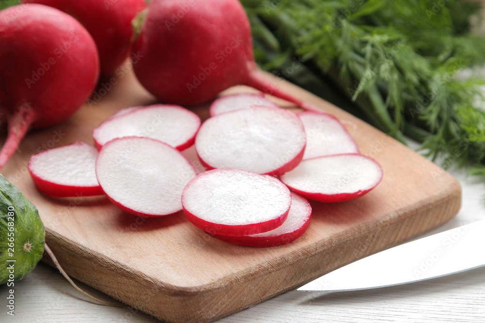 fresh radish. Spring fresh vegetables radishes, cucumber, green onions and greens on a white wooden table. ingredients for cooking. fresh radish. Spring fresh vegetables radishes, cucumber, green onions and greens on a white wooden table. ingredients for cooking.