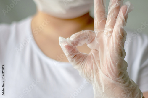 Hand in white latex surgical glove. Hand gesture on white background