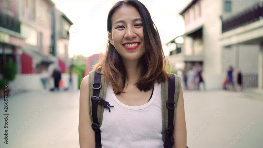 Cheerful beautiful young Asian backpacker woman feeling happy smiling to camera while traveling at Chinatown in Beijing, China. Lifestyle backpack tourist travel holiday concept. Cheerful beautiful young Asian backpacker woman feeling happy smiling to camera while traveling at Chinatown in Beijing, China. Lifestyle backpack tourist travel holiday concept.