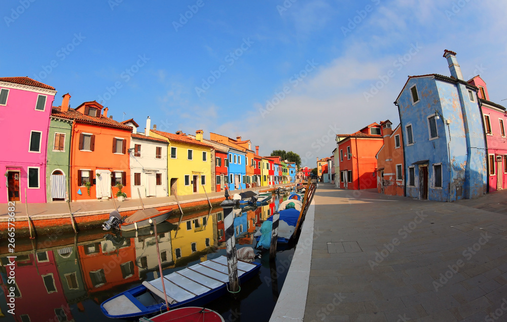 Painted Houses Burano Island near Venice in Italy with blue sky