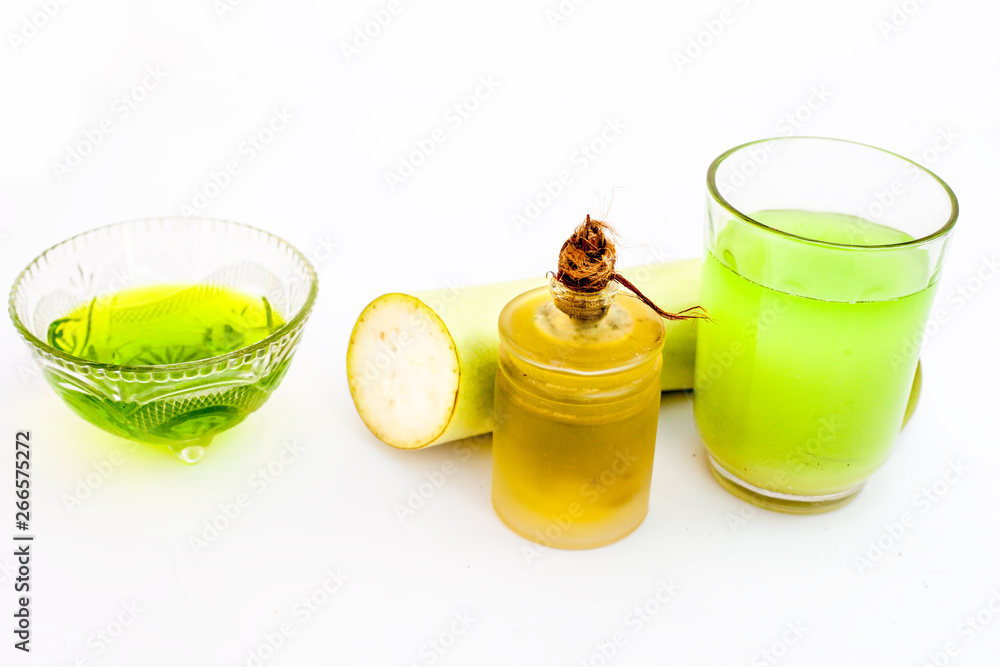 Hair remedy for Grey hair isolated on white . Bottle gourd juice well mixed with olive oil in a glass cup and entire raw ingredients present on the surface. Stock Photo | Hair remedy for Grey hair isolated on white . Bottle gourd juice well mixed with olive oil in a glass cup and entire raw ingredients present on the surface. Stock Photo |