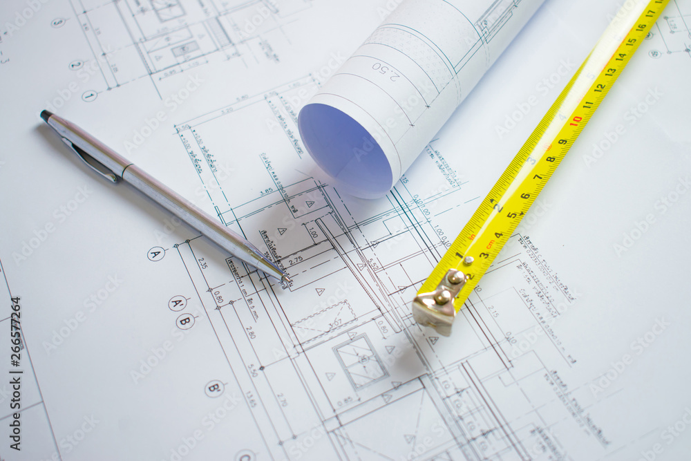 Bangkok, Thailand 28 June 2019: Architect desk with pen, meter cartridge on the blueprint for the house. Bangkok, Thailand 28 June 2019: Architect desk with pen, meter cartridge on the blueprint for the house.