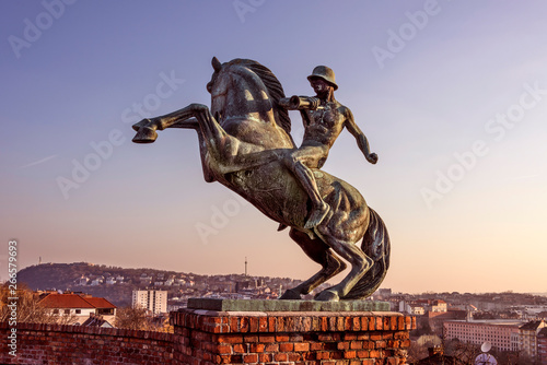 Hungary, Budapest: Equestrian statue of Mounted Messenger horseman at famous Royal Castle Hill near Fisherman's Bastion isolated with skyline of Hungarian capital in the background - concept travel