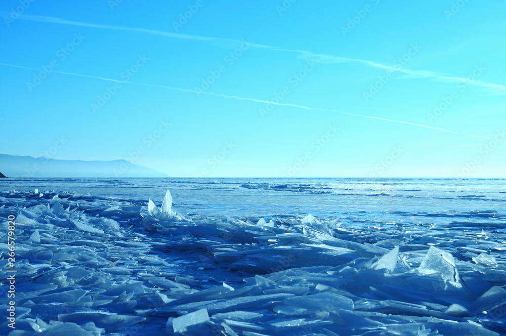 Sun rays are refracted by the transparent ice of Lake Baikal. crystal clear ice fragments — hummocks Sun rays are refracted by the transparent ice of Lake Baikal. crystal clear ice fragments — hummocks