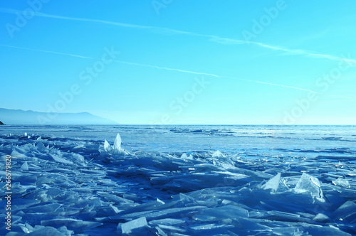 Sun rays are refracted by the transparent ice of Lake Baikal. crystal clear ice fragments     hummocks