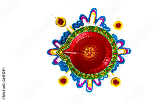 Rangoli and Single Clay diya lamp lit during diwali festival. Happy Diwali Greetings Card Design, Indian Hindu Festival of Lights called Diwali. photo