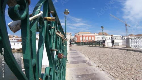 Fixed shot of the padlocks in the  Roman bridge over the Gilao River, Tavira Algarve, Portugal.