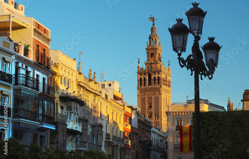 Famous tower of Giralda, Islamic architecture built by the Almohads and crowned by a Renaissance bell tower with the statue of Giraldillo at its highest point, Seville Cathedral. photo