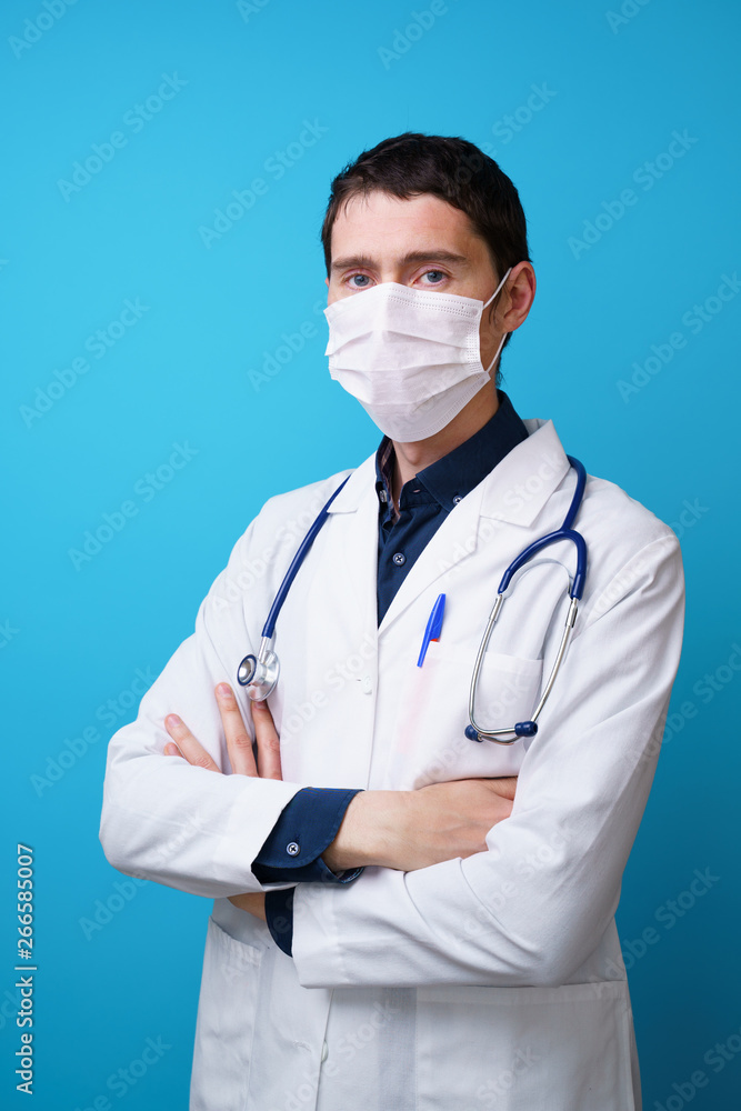 Portrait of a doctor with a stethoscope on the neck and mask on his face. Portrait of a doctor with a stethoscope on the neck and mask on his face.