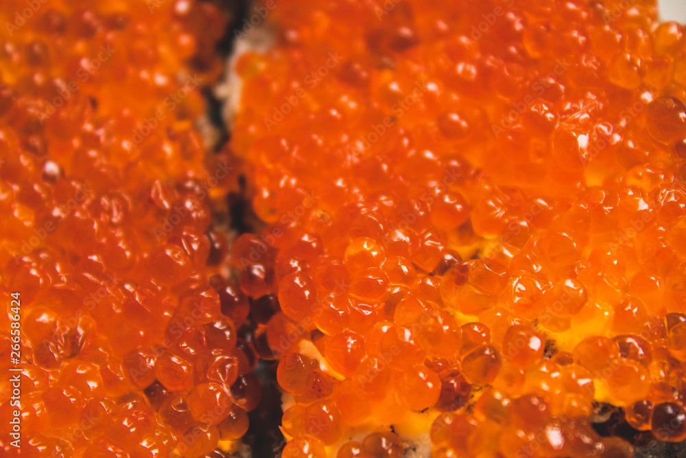Macro photo of red caviar on a white and rye bread sandwich Macro photo of red caviar on a white and rye bread sandwich
