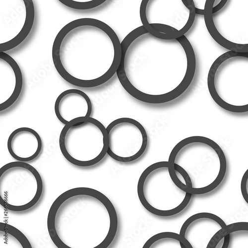 Abstract seamless pattern of randomly arranged black rings with soft shadows on white background