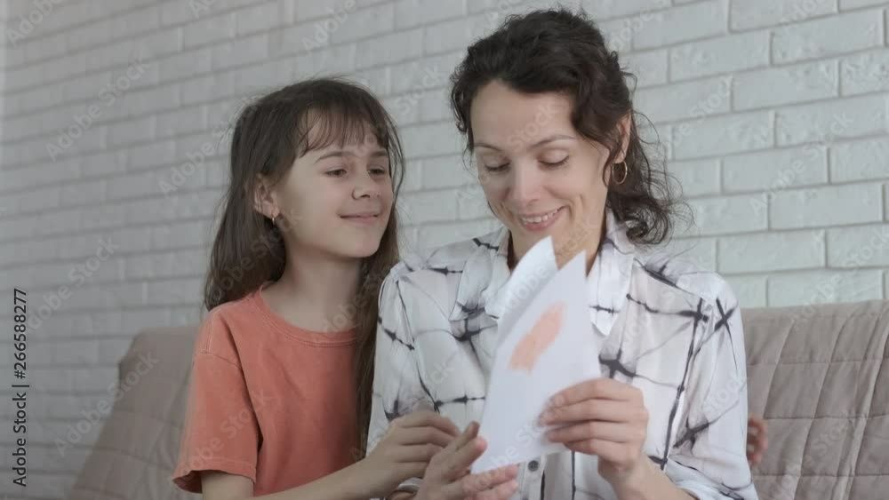 Mothers Day. Heart for mom. Daughter gives mother a card with a heart. Mothers Day. Heart for mom. Daughter gives mother a card with a heart.