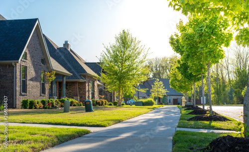 View of modern residential houses neighborhood street in Bentonville, Northwest Arkansas, sunny flare day, fast growing city lifestyle photo