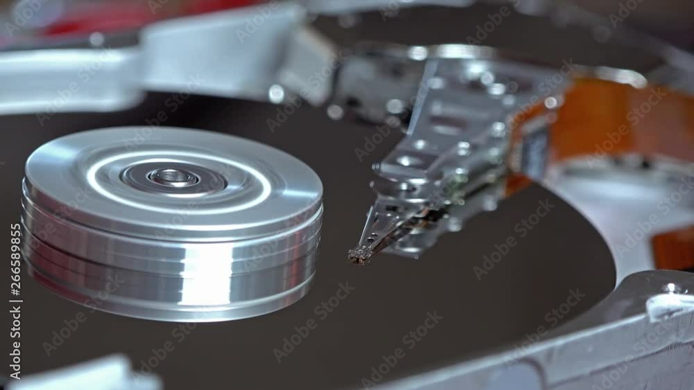 Close-up of an operating computer harddisk reading and writing data Close-up of an operating computer harddisk reading and writing data