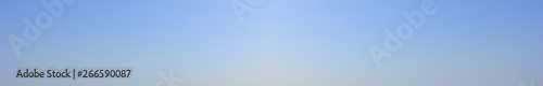 Blue sky background. Empty pale blue sky texture, elongated bluish banner 