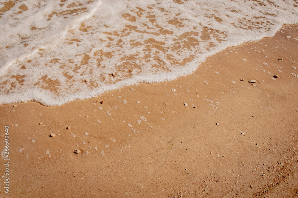 White waves of Azove sea on a red sand. White waves of Azove sea on a red sand.