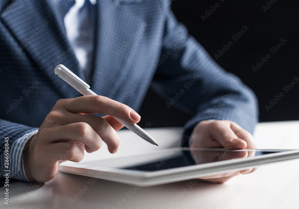 Man in business suit using tablet computer. Man in business suit using tablet computer.