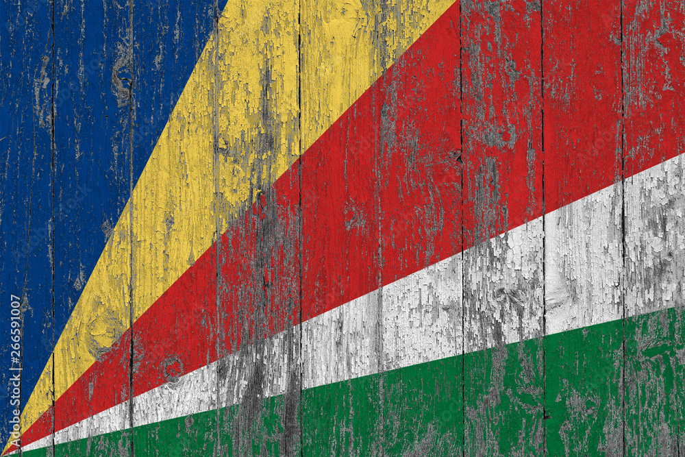 Flag of Seychelles painted on worn out wooden texture background.
