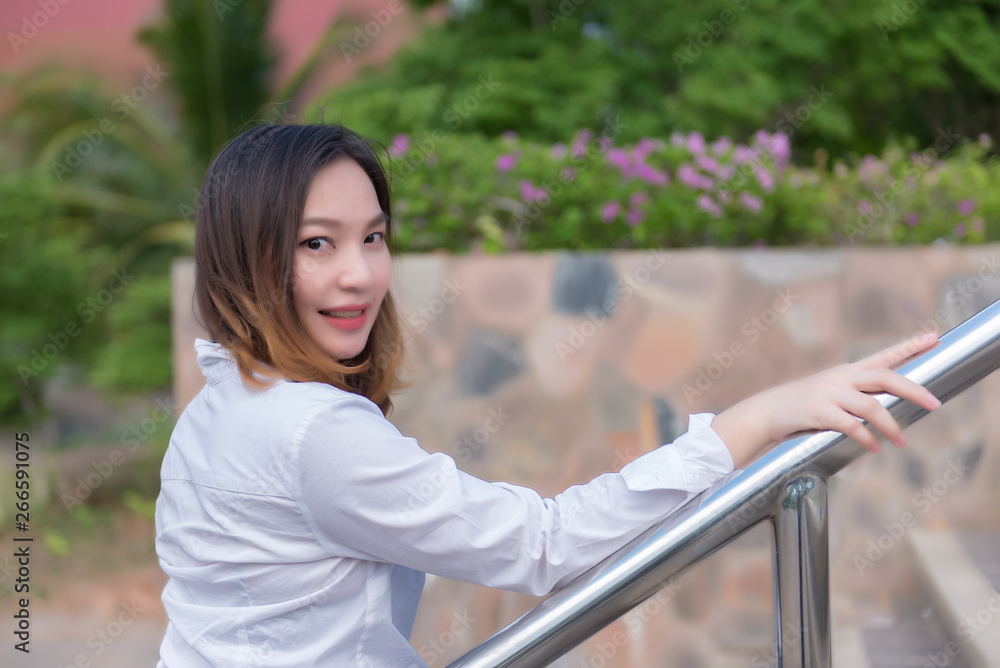 Naklejka premium Portrait of beautiful asian woman post for take a picture at outdoor,Thailand people,A pretty girl has a lifestyle for self