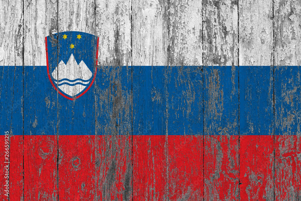 Flag of Slovenia painted on worn out wooden texture background.