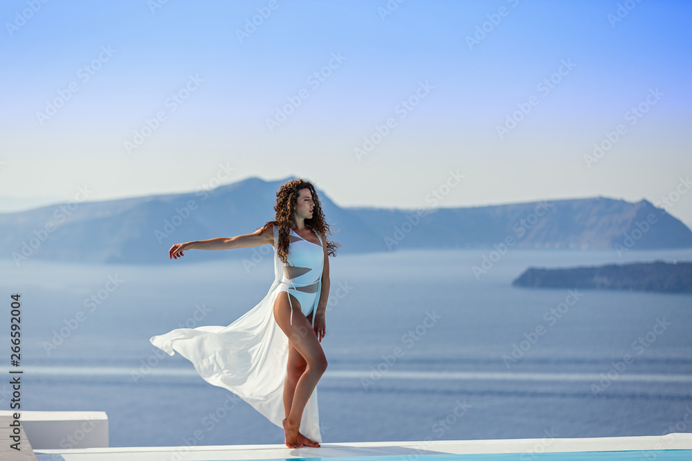 Young woman in a white swimsuit