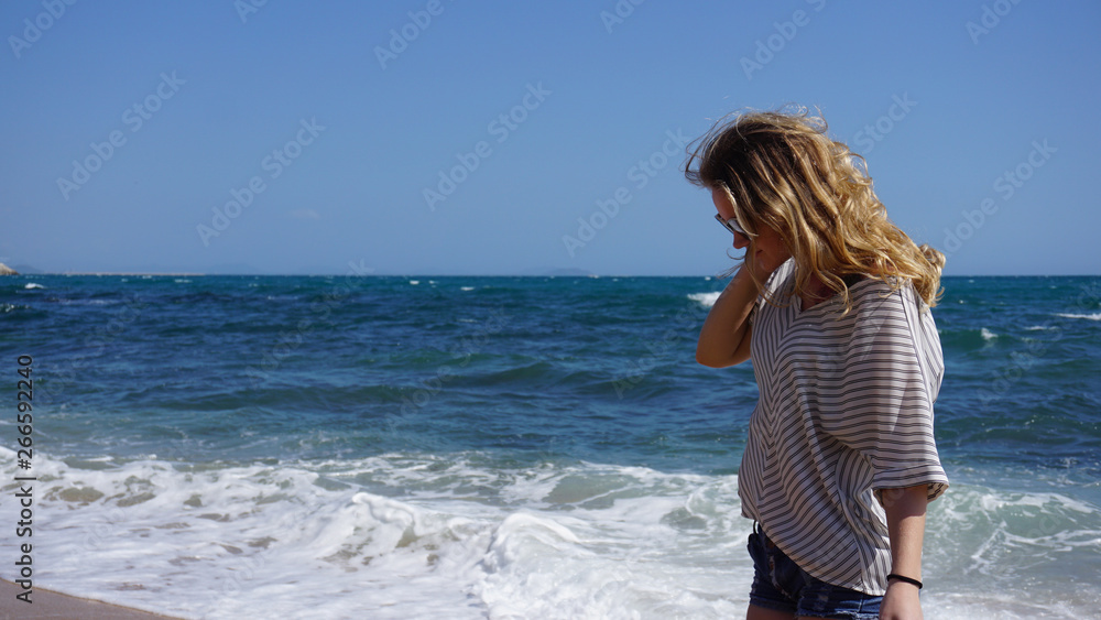 Beautiful bohemian styled and tanned girl at the sea beach in sunlight Beautiful bohemian styled and tanned girl at the sea beach in sunlight