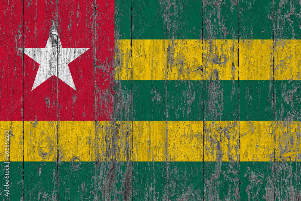 Flag of Togo painted on worn out wooden texture background.