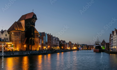 Night view of Motlawa River in Gdansk old town, with dominating building of an old, medieval crane