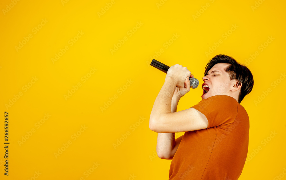 Karaoke man singing a song into a microphone, on a yellow background. A funny man holds a microphone in his hand at the karaoke singer singing a song! Pivets on a yellow background Karaoke man singing a song into a microphone, on a yellow background. A funny man holds a microphone in his hand at the karaoke singer singing a song! Pivets on a yellow background