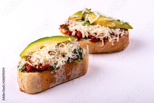 Delicious Italian antipasti bruschetta on white background. Macro.