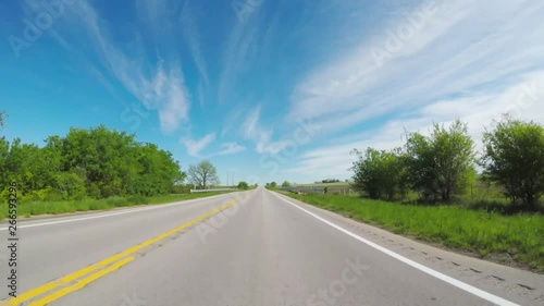 POV. Point of view countryside in the springtime.  View of beautiful open green areas beside the  road.