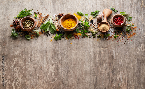 Fresh herbs with spices on wooden background
