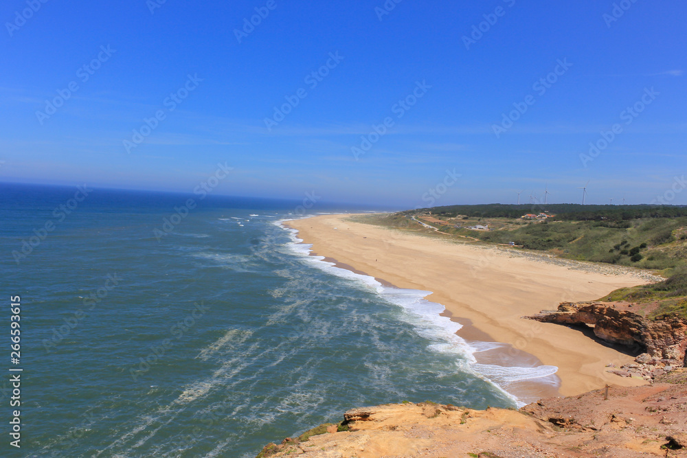 Amazing view of North Beach (Praia do Norte) coastline of Atlantic ocean. Most famous place of giant breaking waves for surfers from around the world. Nazare, Portugal