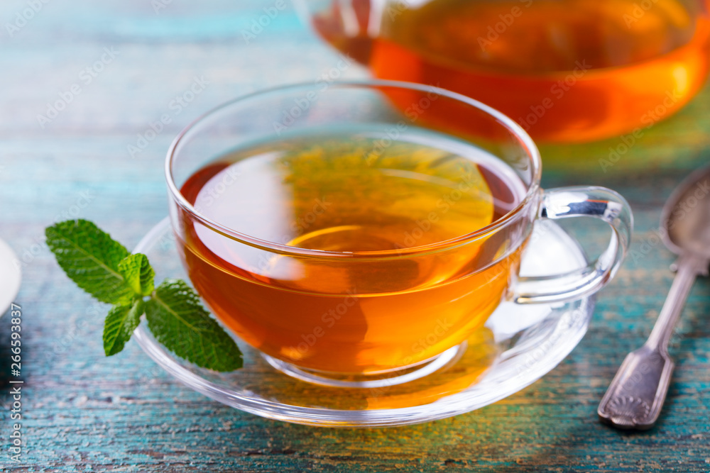 Tea cup with mint leaf and lemon. Close up. Tea cup with mint leaf and lemon. Close up.
