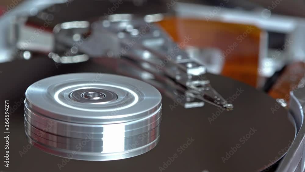 Close-up of an operating computer harddisk reading and writing data Close-up of an operating computer harddisk reading and writing data