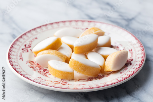 Calissons on a plate. Marble background. Traditional French Provence sweets.